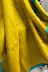 Yellow- greenish pure matka silk saree with contrast firozi border and sequins pallu