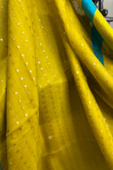 Yellow- greenish pure matka silk saree with contrast firozi border and sequins pallu