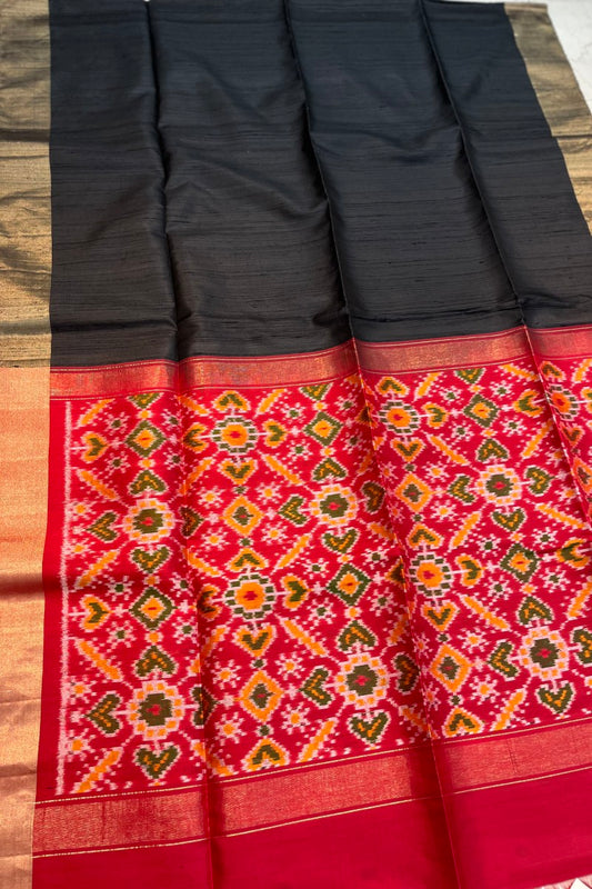 Jet Black Pure Raw Silk Saree with woven Red Ikkat Pallu and Blouse