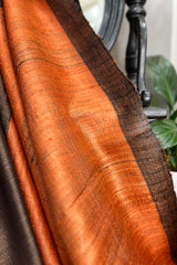 Vibrant Rust coloured Pure Tussar Silk saree with black border and pallu