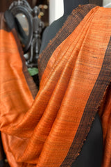 Vibrant Rust coloured Pure Tussar Silk saree with black border and pallu